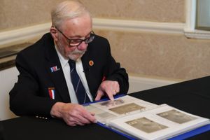 Alan Kennett looking at photos (Lucy North/PA)
