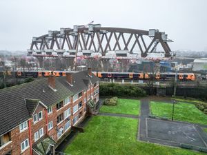 The Bellingham Bridge, one of the tallest HS2 bridges, dwarfs residential flats in Birmingham.  January 19, 2025.  