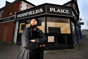 Prince Hussain, owner of Pennfields Plaice, Wolverhampton, next to his boarded up windows after the chippy was targeted on New Year's Eve