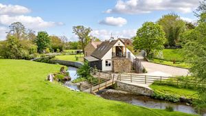 The Mill boasts 14 acres of land in total and a stream runs through its grounds. Picture: Knight Frank/Rightmove.