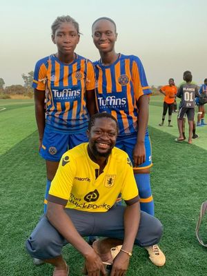 Kevin Boucal with two of his female players in donated Shrewsbury Town Football Club kit