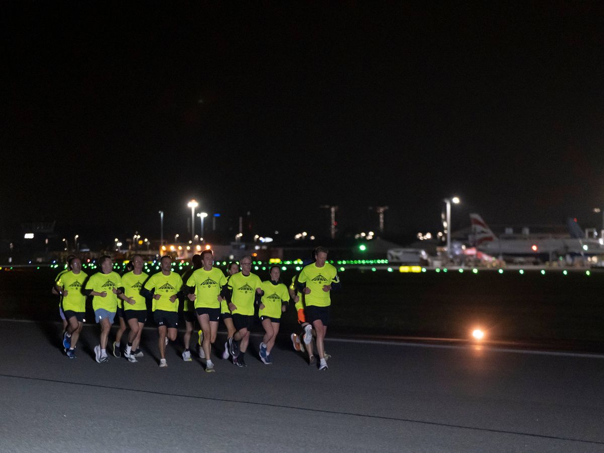 Joggers take off along runway in night-time airport fun run
