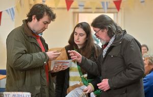 Examining the goods at potato day.