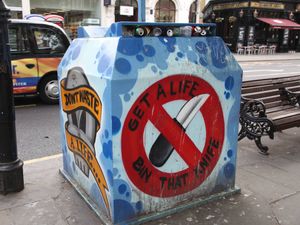 An anti-knife recycling bin on a street in London