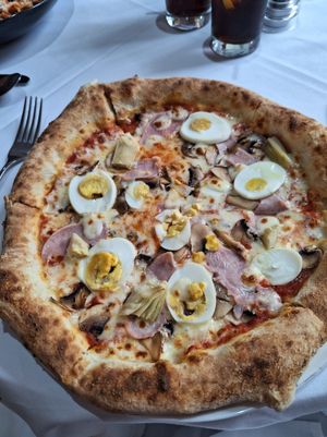Capricciosa which was a pizza topped with tomato, mozzarella, ham, hard boiled eggs, mushrooms and artichokes. 