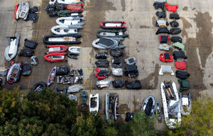 Small boats used to cross the Channel by migrants are stored at a warehouse facility in Dover