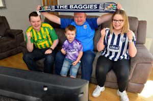 Getting ready for the big game: Dad Alistair Jones with son Oliver Jones, five, daughter Millie Jones ,14, and son Liam Jones,17