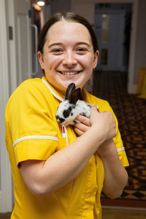 Naiomi Austin (Domestic Cleaner) with an Old English Cross Baby Rabbit