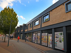The hoardings are off on redeveloped shops on Limes walk , Oakengates ..