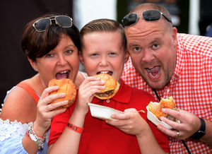 Jo and Richard Carless, with 10-year-old son Howie, take a bite of the action