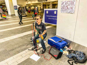 Supporting image for story: Busker belts out tunes at train station to celebrate release of new Top Gun film