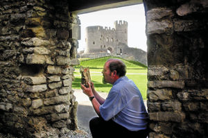 Keeper of Dudley Castle Adrian Durkin examines a brick which was shaken free