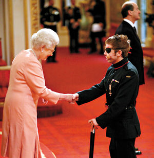 Being decorated with the Military Cross at Buckingham Palace by the Queen.