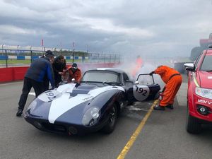 Supporting image for story: Classic car engulfed in flames as driver races back to fire truck