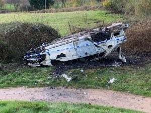 Supporting image for story: Overturned car set on fire next to first tee of golf course
