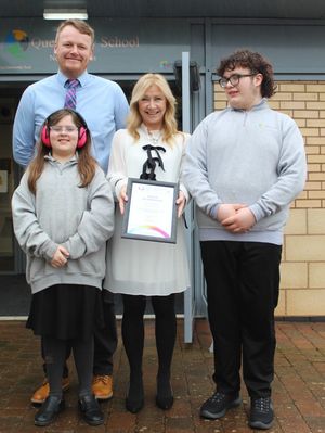 Celebrating the accreditation are, from left, deputy head Stuart Sprague, year seven pupil Kit French, principal Julie Bravo, and year 10 pupil Noah Wise.