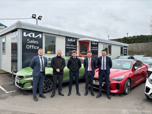 Brindley Kia sales team outside temporary sales office. 