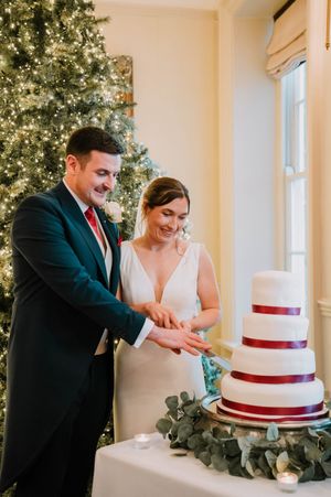 Emma and James cutting their cake at Peterstone Court