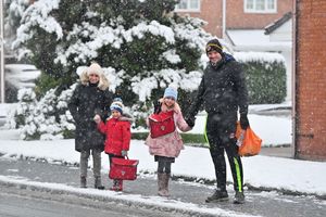 Katie and Steven with youngsters Zachary and Eliza braved the snow for the school run in Perton near Wolverhampton