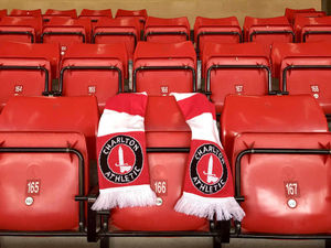 Charlton Athletic officials lay a scarf on Pc Palmer's season ticket seat
