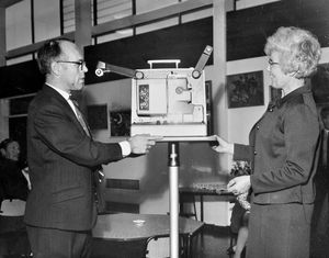 A presentation at Dothill Junior School, Wellington, in July 1970. The caption reads: 'Mr C Henderson, chairman of the parent-teacher association of Dothill Junior School, last night handed over to the school a film projector and accessories worth nearly £400. He presented it to the school's headmistress, Mrs J E Beard, during a social evening.'  