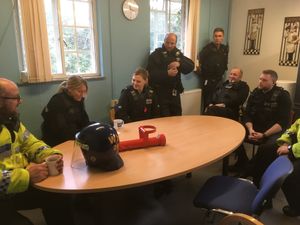 Officers in a briefing at Welshpool Police Station
