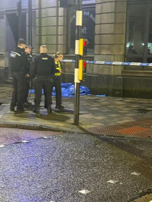 Lichfield street stabbing: police standing at cordoned off street