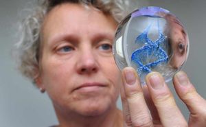 Andrea with a paper weight with cremated ashes in the centre