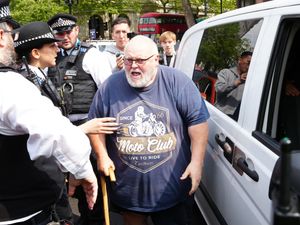 A man speaking to police officers after protesters from Just Stop Oil