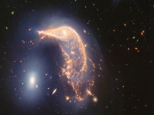 Supporting image for story: Webb Space Telescope’s cosmic shot shows intertwined galaxies glowing infrared