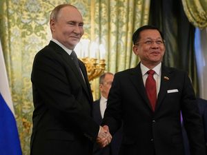 Russian President Vladimir Putin, left, and Myanmar’s Military leader Gen Min Aung Hlaing shaking hands