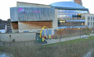 Environment Agency workers erecting flood defences at The Theatre Severn, Shrewsbury