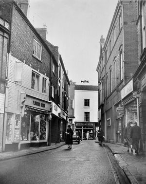 Market Street in Wellington, with the town square visible at the far end. Visible shops are Florence Dixon, The Square, and Adlard