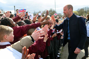 The Prince of Wales high fives schoolchildren from Fibbersley Park Primary Academy 