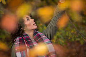 Young woman enjoying spending time out in nature during the season of autumn