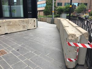 Concrete blocks have been placed on the pavement outside