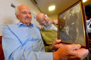 Ron and Roy Tomlin hold a picture of themselves as children