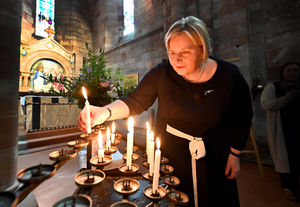 Donna Ockenden lights a candle