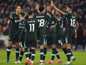 Liverpool's players celebrate after Mohamed Salah scored their third goal at the London Stadium