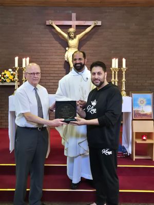 Keith presented by Shaz Saleem. L to R Keith Clark, Fr Shanju, Shaz Saleem 