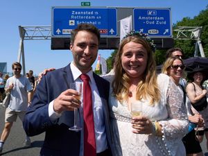 Supporting image for story: Couples tie the knot during a festival on an Amsterdam ring road