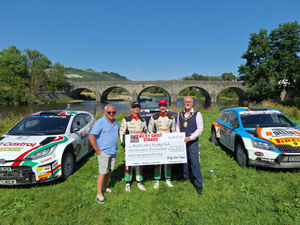 Builth Wells Mayor Councillor Mark Hammond accepting a cheque from Mr Nicky Grist, on behalf of Builth Rugby club