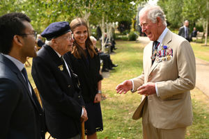 The Prince of Wales chats with a veteran after the national service of remembrance marking the 75th anniversary of VJ Day at the National Memorial Arboretum in Alrewas, Staffordshire. Photo: Oli Scarff/PA Wire.