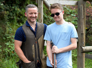 New generation: Paul Gormley, 39, from Wall Heath, near Dudley, takes son Rhys, 15, shooting at Millride