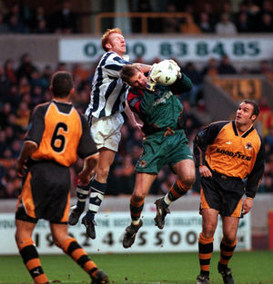 Wolves keeper Mike Stowell just beats Albions Lee Hughes to this cross.