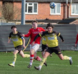 Whitchurch Alport's Josh Madley battles for the ball.