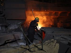 A British Steel worker at a furnace