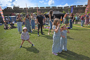 Revellers at Shrewsbury Castle watching Loopfest on Sunday