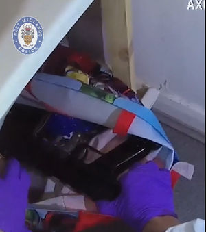 Police discovered six guns hidden behind a bath panel at the address