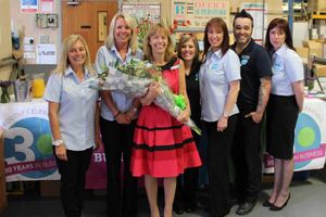 Sophia Powell (in red) with members of staff.